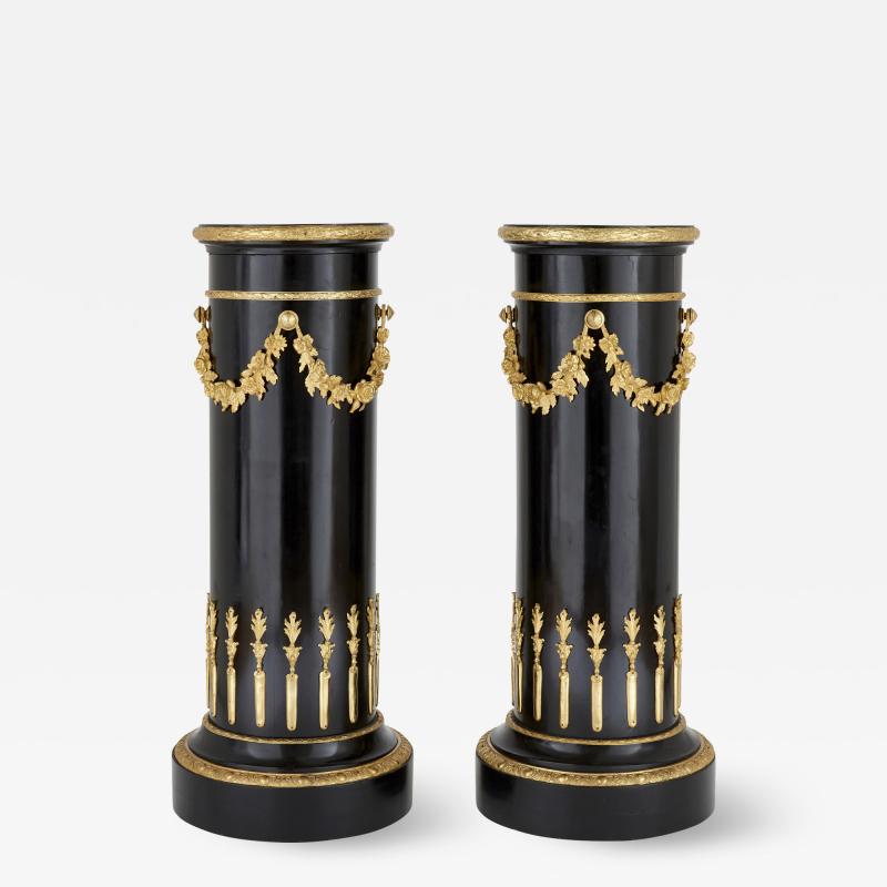 Pair of Neoclassical style gilt bronze and ebonised wood stands