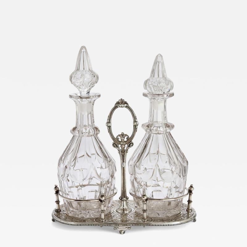 Pair of antique English cut glass decanters with silver plated stand