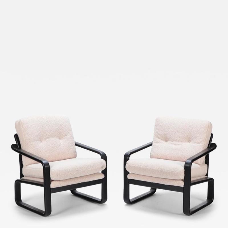 Pair of ebonized French open armchairs recently upholstered in Boucle fabric 