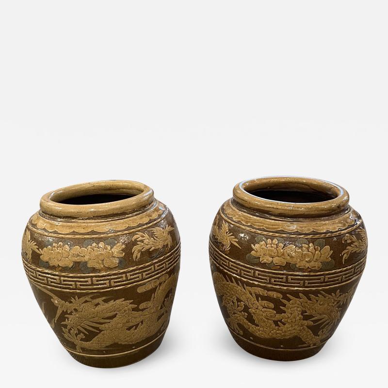 Pair of glazed ceramic Chinese export planters with a dragon motif and Greek key