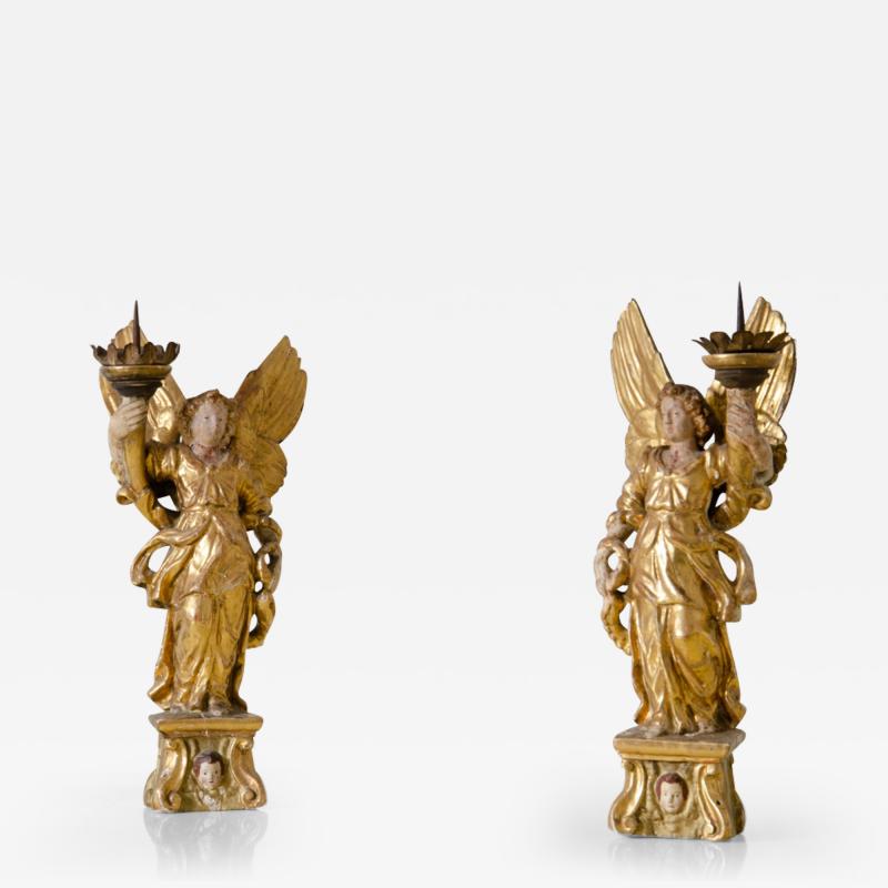 Pair of lacquered and gilded wood angels holding a cornucopia