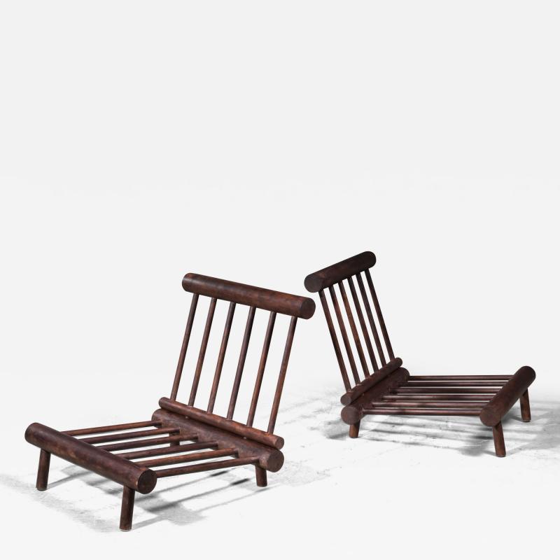 Pair of low chauffeuse fireside lounge chairs in oak for Les Arcs