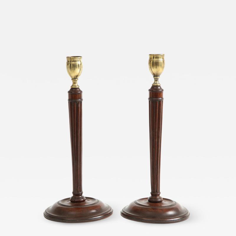 Pair of mahogany and brass candlesticks