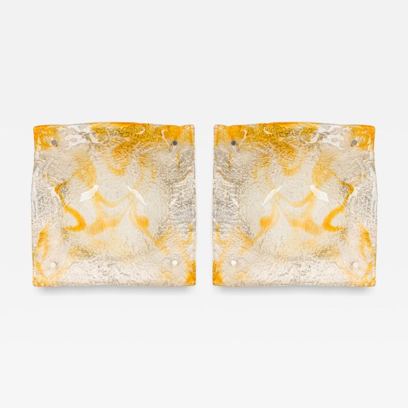 Pair of textured clear and amber glass sconces with a half round freeform design