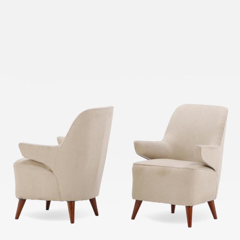 Pair of upholstered lounge chairs circa 1950 having floating arms and new fabric