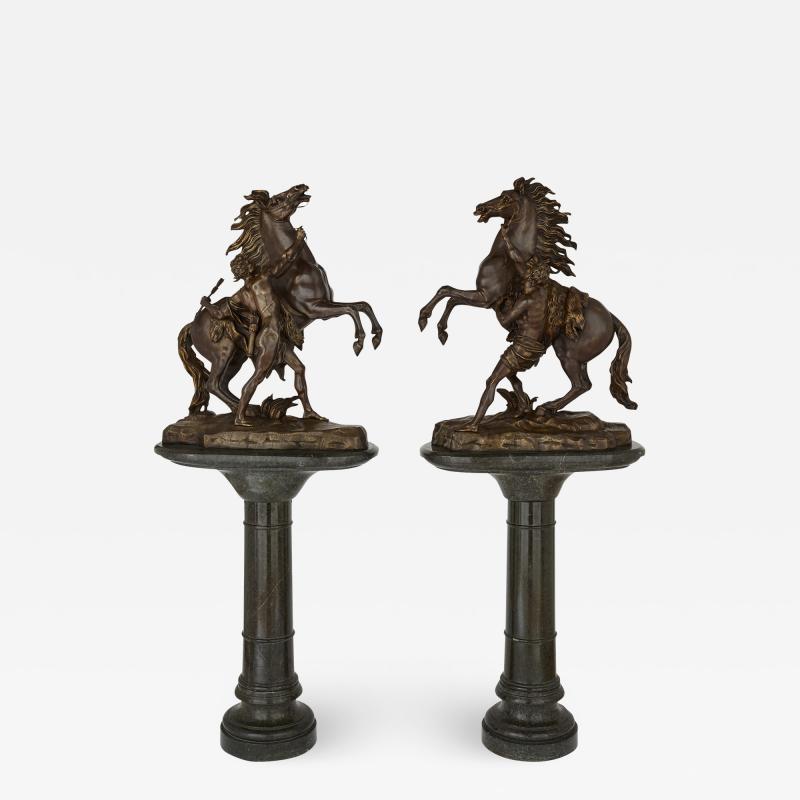 Pair of very large patinated bronze Marly horses with marble pedestals
