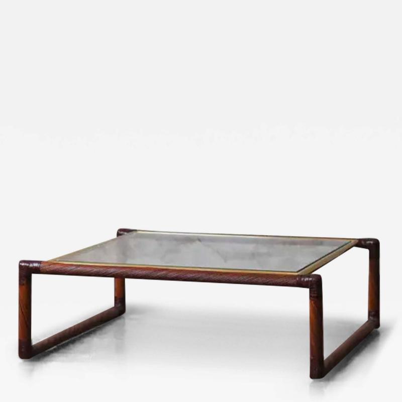 Rattan coffee table with leather bindings brass details and glass top 1970s