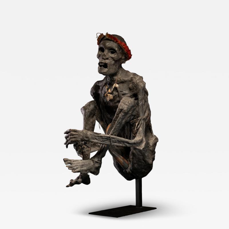 Sculptured model of a smoked Papua Mummie papier m ch 20th C