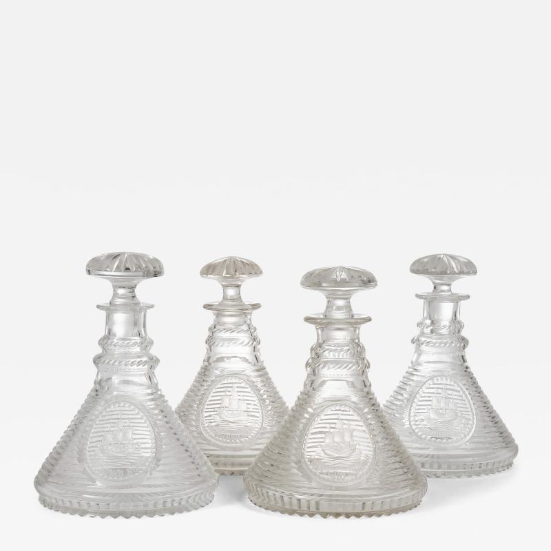 Set of four English engraved and cut glass ships decanters