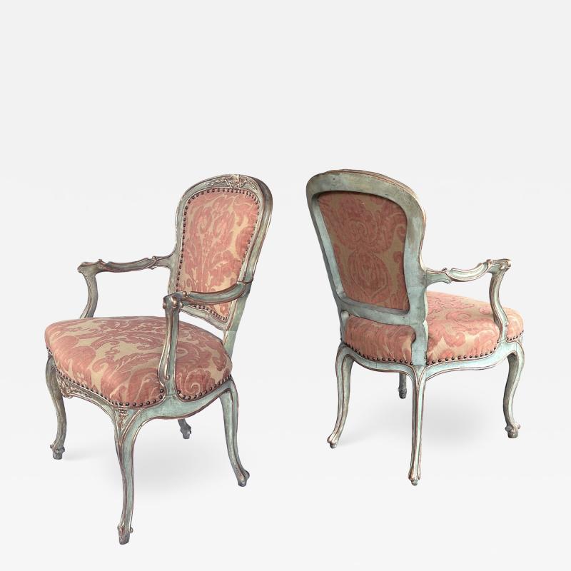 Shapely pair of Italian rococo style aqua painted and parcel gilt armchairs