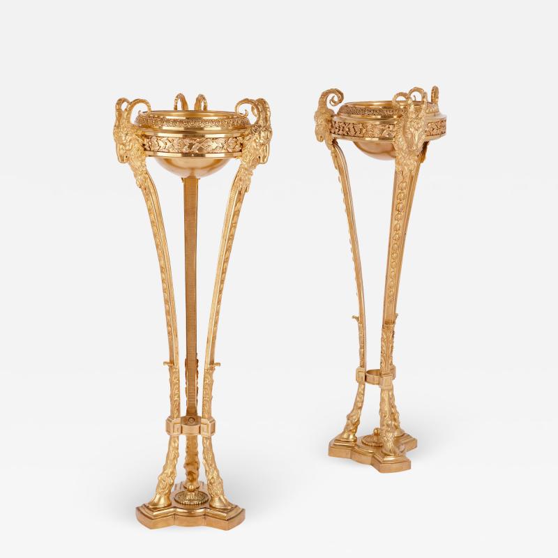 Two antique Neoclassical style gilt bronze tripod stands