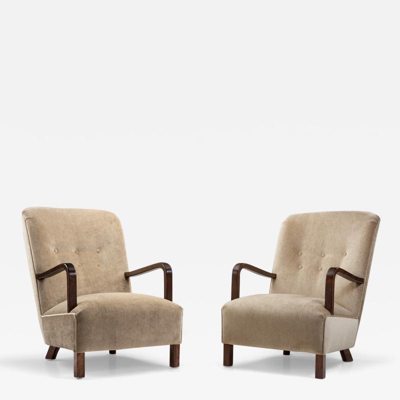 Upholstered Lounge Chairs with Sculptural Arms Europe ca 1940s