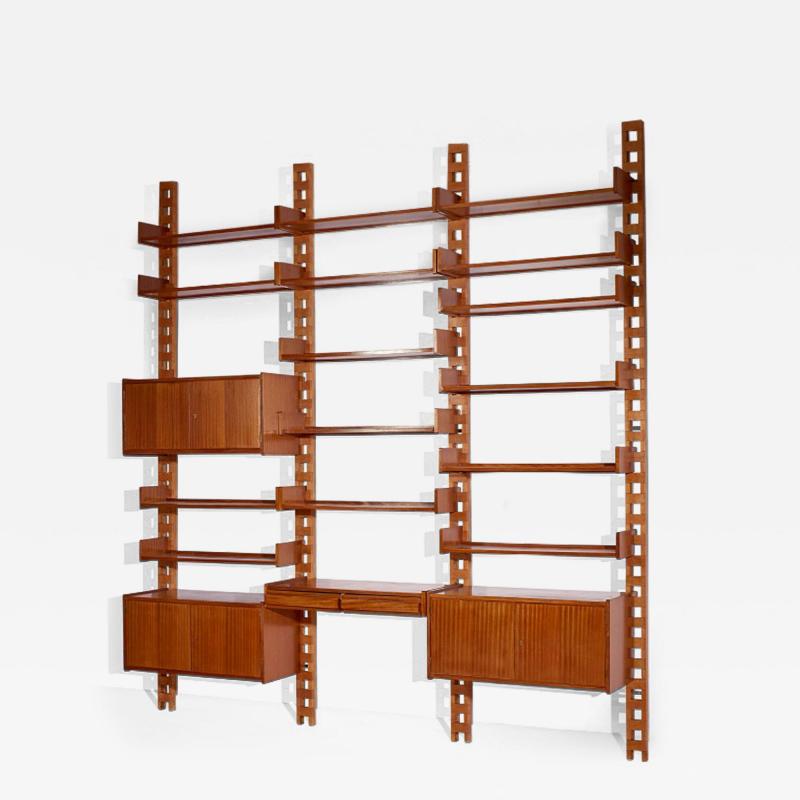 Wall mounted bookcase with wooden uprights and modules Italy 1950s