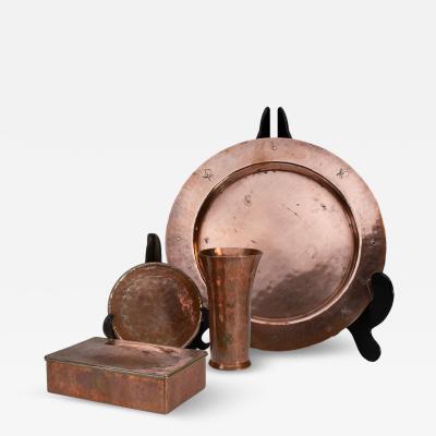  Birmingham Guild of Handicraft An Arts Crafts four piece hand hammered dressing table or desk set