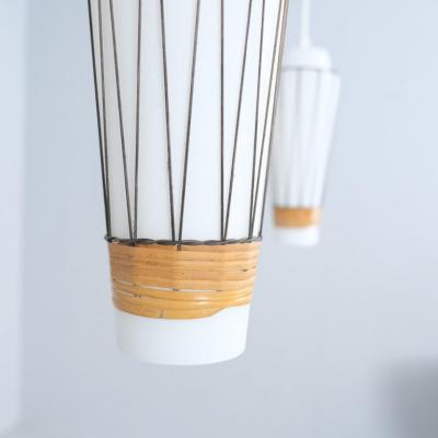  Idman Oy Pair of Mid Century Modern Pendants Model K 3 3 in Glass and Rattan Idman 1950s