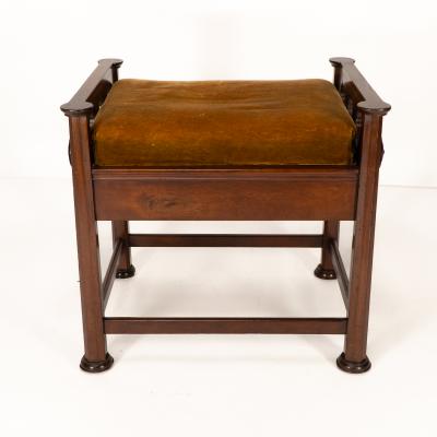  J S Henry J S Henry in the style of Voysey An Arts Crafts walnut adjustable piano stool