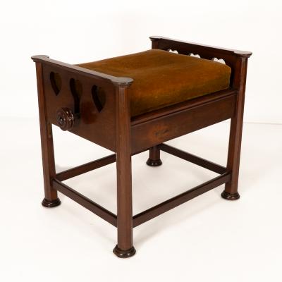  J S Henry J S Henry in the style of Voysey An Arts Crafts walnut adjustable piano stool