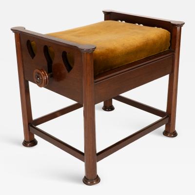  J S Henry J S Henry in the style of Voysey An Arts Crafts walnut adjustable piano stool
