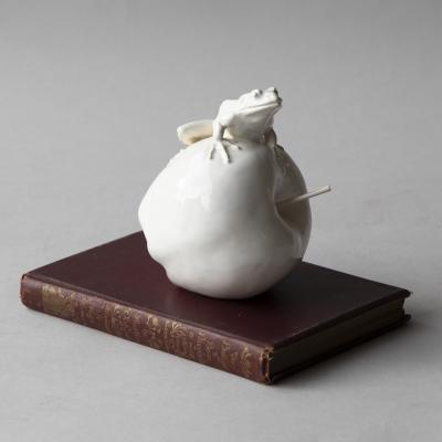  Jean Paul Gourdon SCULPTURE OF A SMALL FROG SITTING ATOP AN APPLE IN GLAZED WHITE FA ENCE