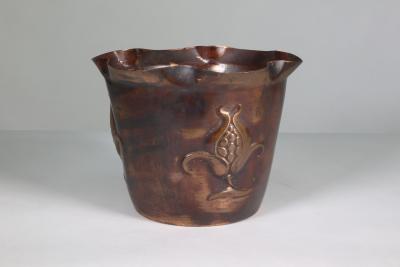  Joseph Sankey Sons Joseph Sankey Sons An Arts Crafts copper planter with embossed flower pod