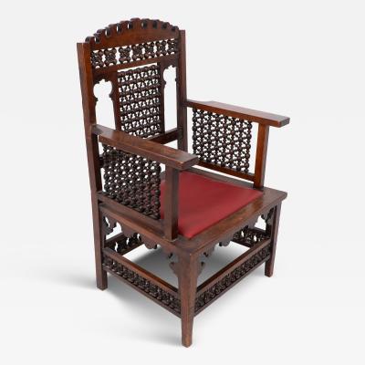 Liberty Co Liberty Co A Moorish walnut armchair with Mashrabiya turned details throughout