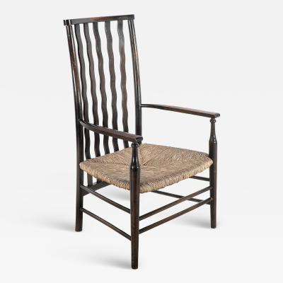  Liberty Co Liberty Co An Arts Crafts Rush Seat Armchair with Wavy Shaped Back Slats