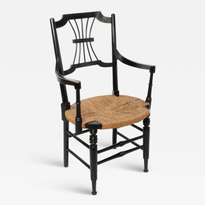  Liberty Co Liberty Co an English Aesthetic Movement Ebonised Armchair with Seagrass Seat