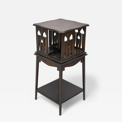  Liberty Co Liberty and Co An oak revolving bookcase with stylized floral cut out decoration