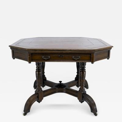  MAPLE Co Maple Co a Gothic Revival Oak Leather Top Writing Table on Decorative Castors