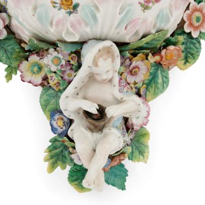  Meissen Porcelain Manufactory Pair of Meissen style porcelain and ebonised wood mirrored wall brackets