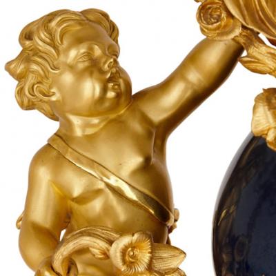 Popon A Paris Large cherub themed gilt bronze clock garniture by Popon