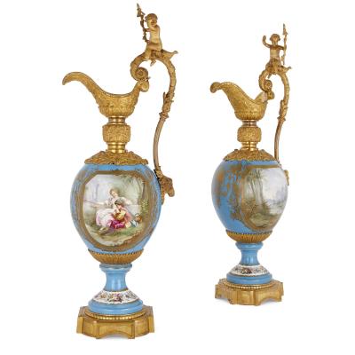  S vres Porcelain Manufactory Two large Rococo style porcelain and gilt bronze jugs