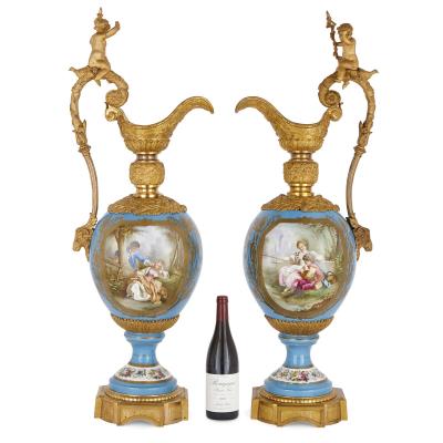  S vres Porcelain Manufactory Two large Rococo style porcelain and gilt bronze jugs