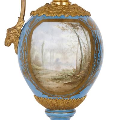  S vres Porcelain Manufactory Two large Rococo style porcelain and gilt bronze jugs