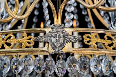  Werner Mieth A GERMAN NEOCLASSICAL SILVER AND GILT BRONZE TWELVE LIGHT CRYSTAL CHANDELIER