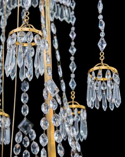  Werner Mieth A GERMAN NEOCLASSICAL SILVER AND GILT BRONZE TWELVE LIGHT CRYSTAL CHANDELIER