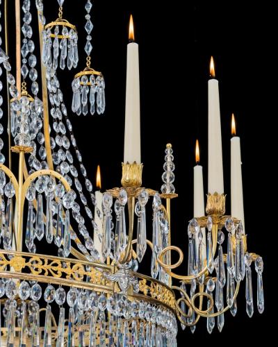  Werner Mieth A GERMAN NEOCLASSICAL SILVER AND GILT BRONZE TWELVE LIGHT CRYSTAL CHANDELIER