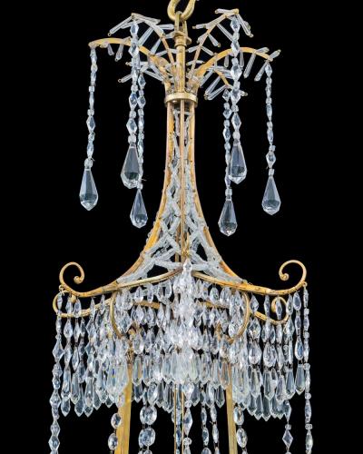  Werner Mieth A GERMAN NEOCLASSICAL SILVER AND GILT BRONZE TWELVE LIGHT CRYSTAL CHANDELIER