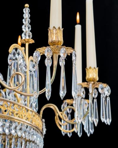  Werner Mieth A GERMAN NEOCLASSICAL SILVER AND GILT BRONZE TWELVE LIGHT CRYSTAL CHANDELIER