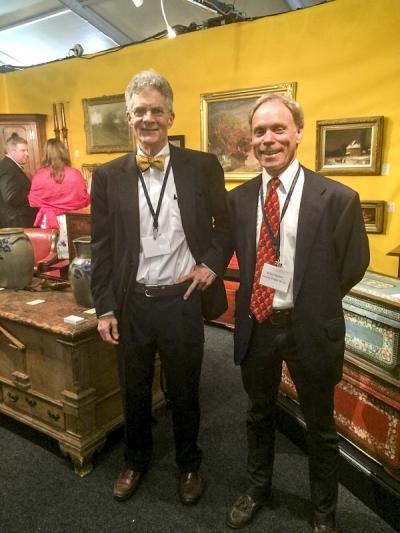 Southern furniture expert and exhibitor Sumpter Priddy in his booth with a colleague.