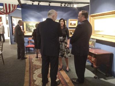 Robert (right) and Deepali (center) Schwarz of Schwarz Gallery, speak to a collector in their booth.