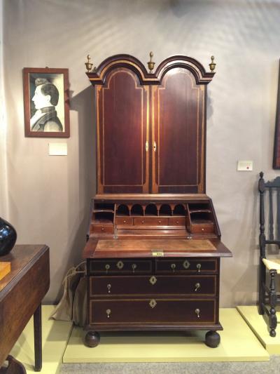 An early desk and bookcase, Boston, 1710-1720, with architectural inlays, was offered in the booth of Peter Eaton American Antiques.