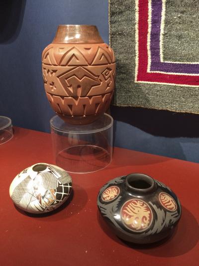 A polychrom seed jar (lower right) by Grace Medicine Flower and Camilio Tafoya, 2004; a Hopi seed jar (lower left) signed "Syliva Naha/Featherwoman S; and a Navajo/Santa Clara tall jar by Harrison Begay Jr., were all offered by Marcy Burns American Indian Arts."