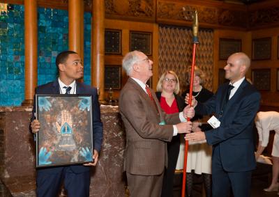 In honor of 25 years as chairman of the show, Arie Kopelman is presented with an Odd Fellows staff. Denzel Saunders (left) and Daniel Diaz, director of Eastside House Settlement, the show