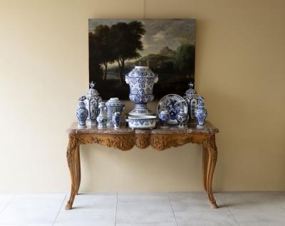 18th FRENCH SCHOOL LANDSCAPE WITH A FORTIFIED SETTLEMENT AND ANIMALS GRAZING