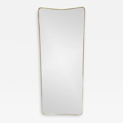 1950S LONG SLIGHT CURVED MIRROR IN AGED BRASS IN THE STYLE OF GIO PONTI