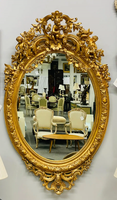 19th Century Palatial Giltwood Wall or Console Mirror Adorning Three Cherubs