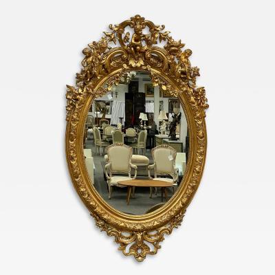 19th Century Palatial Giltwood Wall or Console Mirror Adorning Three Cherubs