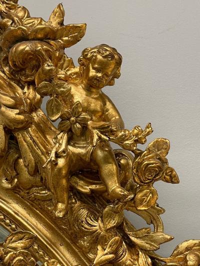19th Century Palatial Giltwood Wall or Console Mirror Adorning Three Cherubs