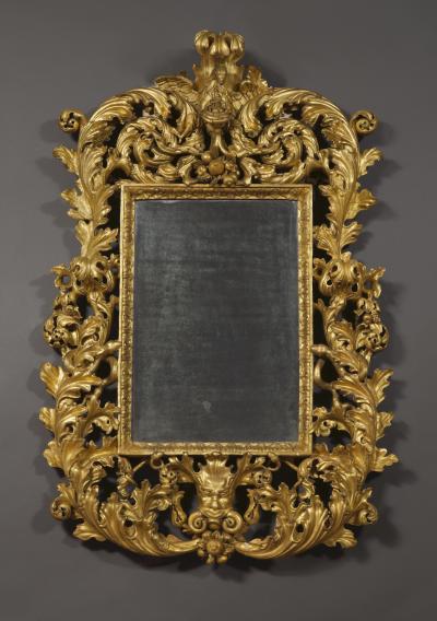 A BAROQUE ACANTHUS GILTWOOD MIRROR CARVED WITH UNUSUAL SERPENT
